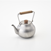 A Miyaco Classic stainless steel teapot with a brushed metal finish, overhead wooden handle, and a cork lid knob.