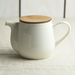 Detailed view of the Miyama Bico Series teapot showing its smooth white ceramic body and contrasting mustard porcelain lid, highlighting the refined design.