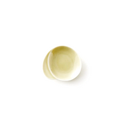 Miyama Gaku mini plate in warm pale yellow glaze with an organic asymmetric form featuring an integrated chopstick rest indent, shown against a white background