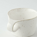 Detailed close-up of the speckled surface of a Miyama Bico Series white mug, showing the fine texture and quality craftsmanship.