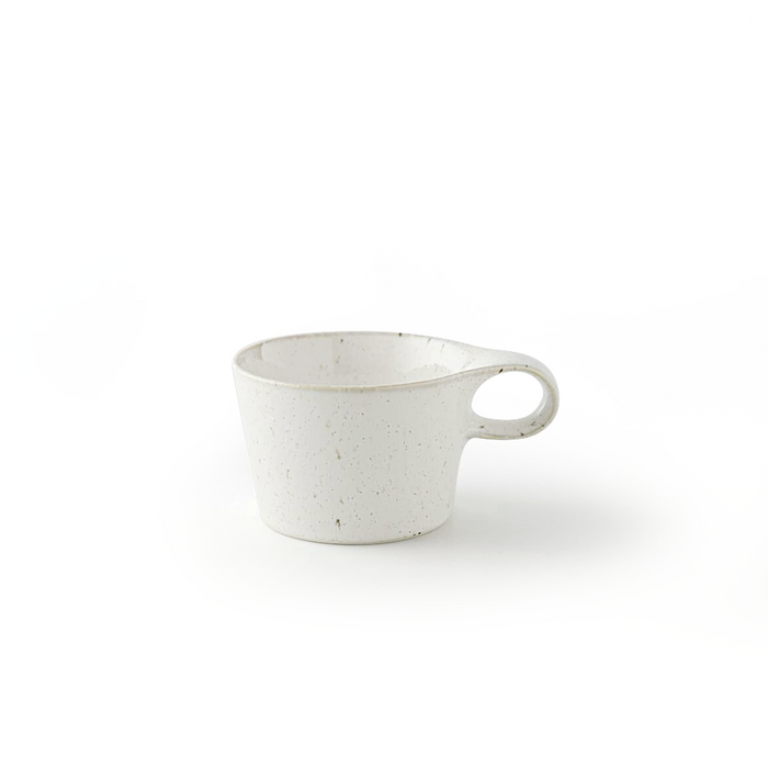 Side view of a Miyama Bico Series white speckled mug, emphasizing its sleek design and ergonomically shaped handle.