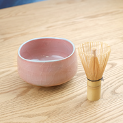 The Momoyama Red Crackle matcha bowl (chawan), featuring a vibrant reddish-pink crackle glaze, an irregular rim, and a partially unglazed foot. Made in Japan
