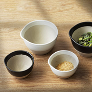 Four ceramic bowls with different contents on a wooden surface