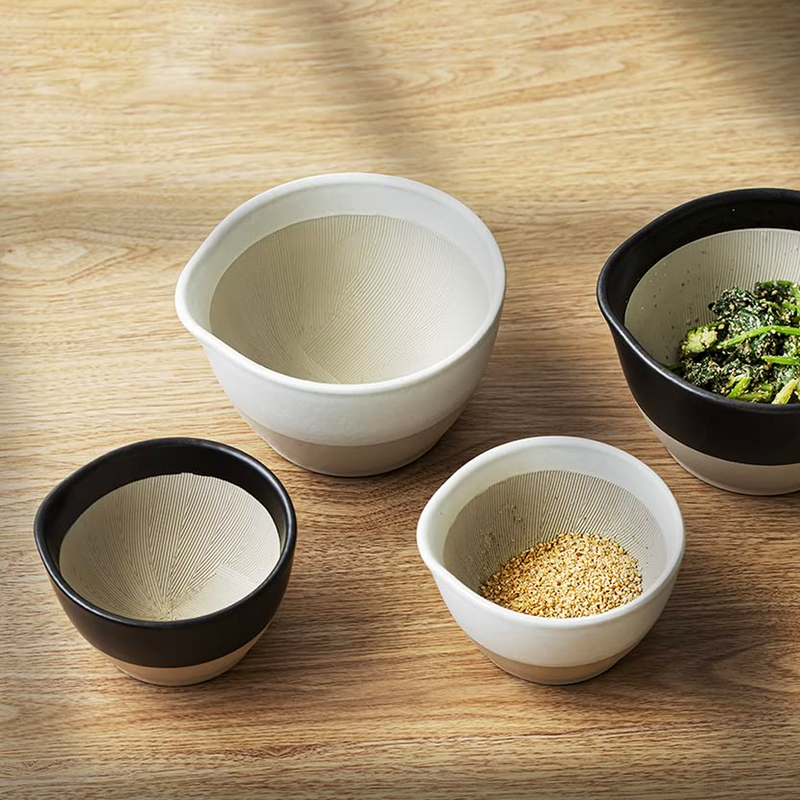 Four ceramic bowls with different contents on a wooden surface