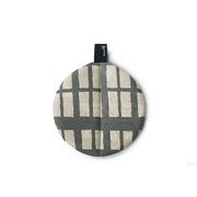 Grey round cotton pot holder with geometric pattern, black hanging loop on white background.