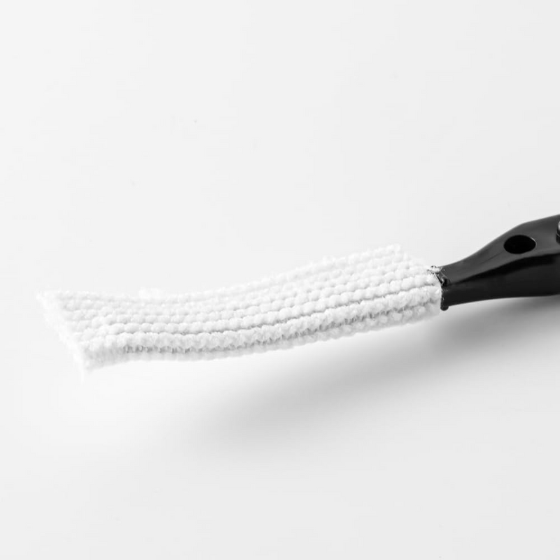 A macro close-up of the white nylon brush head of the &NE Nikii mini cleaning tool, showing its dense fibre texture.