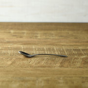 Side view of the Nagomi hammered stainless steel coffee spoon