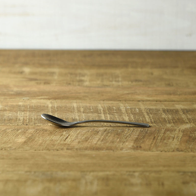 Side view of the Nagomi hammered stainless steel coffee spoon