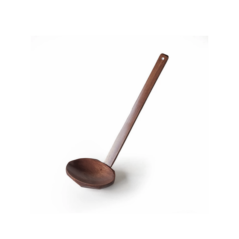 A studio photo of the Nippan Wooden Soup Ladle, showing its dark brown wood, long handle, and deep, curved bowl, angled slightly upwards with a soft reflection below.
