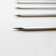 A detailed close-up shot of the sharp, pointed tip of a Nippan chrome-plated steel skewer, highlighting its quality construction for easy piercing of food.