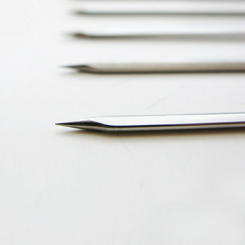 A detailed close-up shot of the sharp, pointed tip of a Nippan chrome-plated steel skewer, highlighting its quality construction for easy piercing of food.
