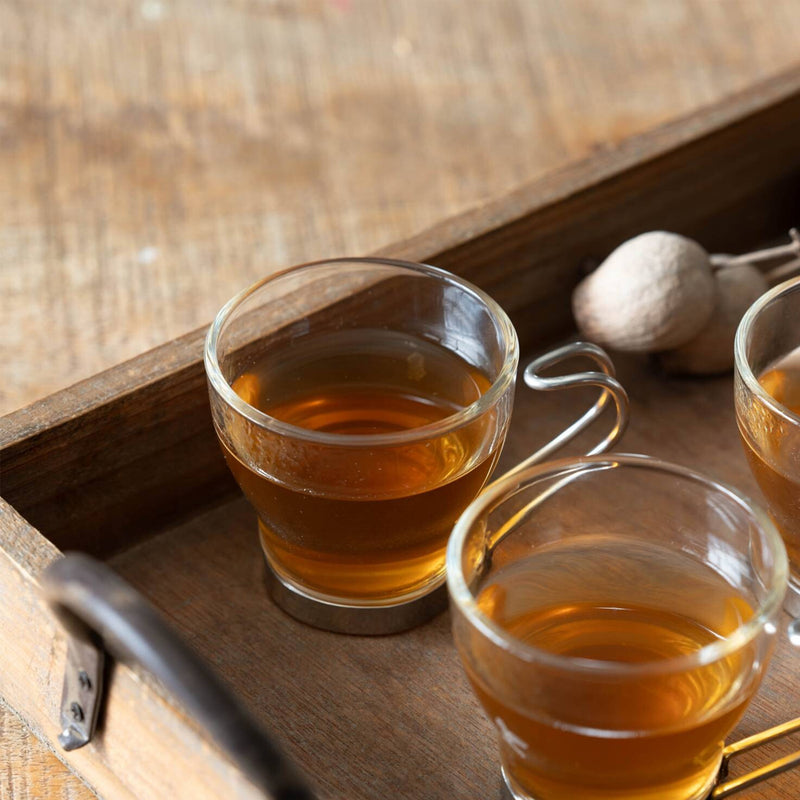 Oslo glass espresso cups filled with tea on a wooden tray