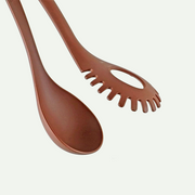 Close-up of the brown nylon heads of the Pearl Life dual-use utensil, showing the slotted pasta fork and the solid serving ladle.
