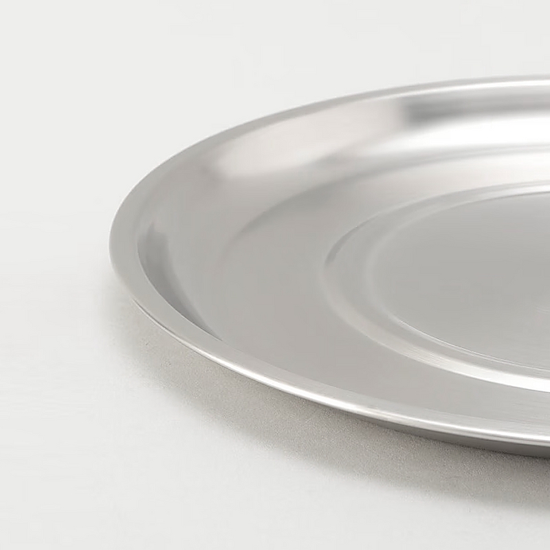 A detailed close-up of the Ryoumiya stainless steel tray, highlighting its smooth rim and brushed finish.

