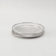 The two-piece Ryoumiya stainless steel set, featuring a round fine-mesh strainer resting neatly on top of its matching solid serving tray.

