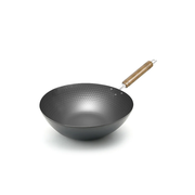 A product image of the Pearl Life 27cm carbon steel wok, showcasing its hammered interior texture and natural wood handle on a white background.

