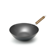 A product image of the extra-large Pearl Life 33cm carbon steel wok, showcasing its hammered interior texture and natural wood handle.

