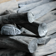 Close-up of Kishu binchotan Japanese white charcoal showing smooth surface and metallic silver ends.