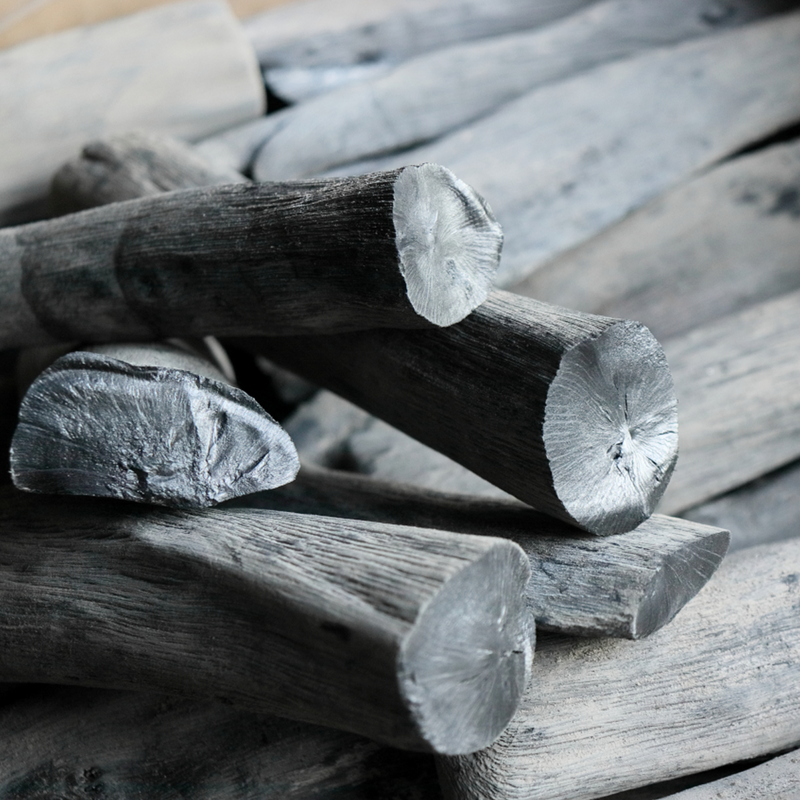 Close-up of Kishu binchotan Japanese white charcoal showing smooth surface and metallic silver ends.