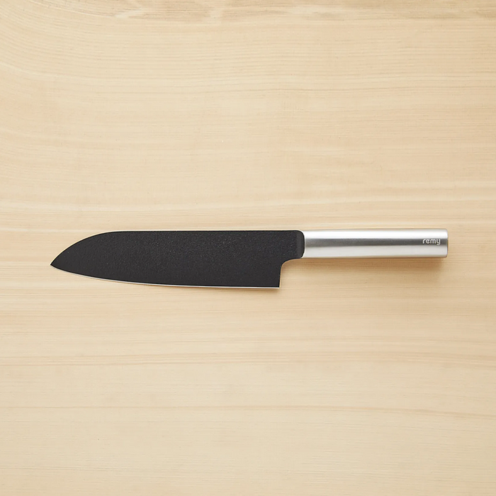 The first image shows the Remy Kuro Japanese Santoku Knife on a wooden background, emphasizing its sleek black blade and polished metal handle, which is marked with the brand name "remy".