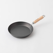 River Light Kiwame 28cm nitrided carbon steel steak pan with a wooden handle, shown on a plain white background.