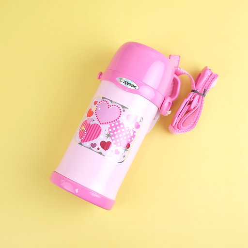 A pink Zojirushi SC-MC60 2-way stainless bottle with a heart pattern, lying diagonally on a yellow background with its matching strap.