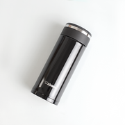 A glossy black Zojirushi SM-JD36 vacuum insulated flask with a screw-top lid lying diagonally on a white background.