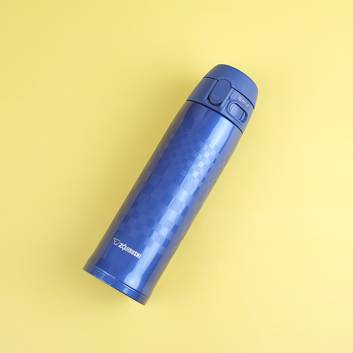 Alt Text: A blue Zojirushi SM-TAE48SA vacuum flask featuring a tonal "Ichimatsu" checkered pattern lying diagonally on a yellow background.
