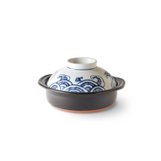 Alt Text for Image
A product image of the Saji Tairyoumaru mini donabe, showing its dark clay base and the lid's traditional blue Japanese wave pattern.
