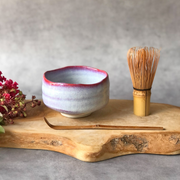 Sakura Unofu Matcha Bowl Set including a pink and white speckled 450ml ceramic bowl, a bamboo whisk (chasen), and a bamboo scoop (chashaku).