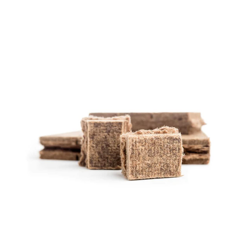 A close-up of several Samba Natural Firelighter cubes, showcasing the rough, fibrous texture of the compressed wood and wax material.

