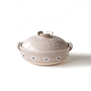 
A product image of the Santo Plum Blossom Donabe, showing its light beige glaze and hand-painted white plum blossom design.

