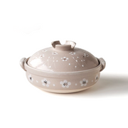 
A product image of the Santo Plum Blossom Donabe, showing its light beige glaze and hand-painted white plum blossom design on a white background.

