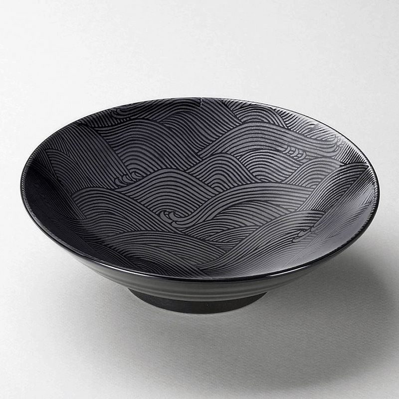 A close-up, angled view of the Seigaiha ramen bowl, highlighting the texture and detail of the ocean wave pattern on the interior.

