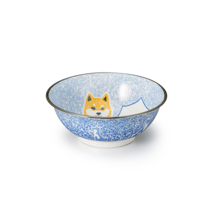 A decorative ceramic ramen bowl featuring a Shiba Inu and Mount Fuji design, shown with a display of chili peppers and a bell, on a white background.