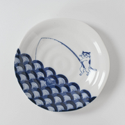 Top view of the plate showing cat fishing design with detailed wave motif.

