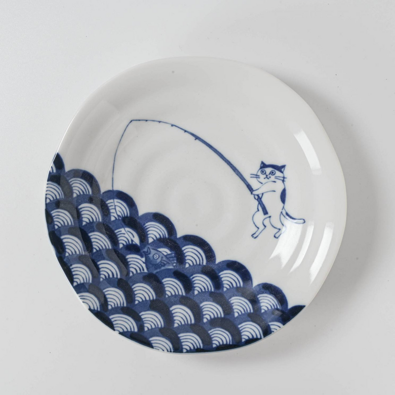 Top view of the plate showing cat fishing design with detailed wave motif.

