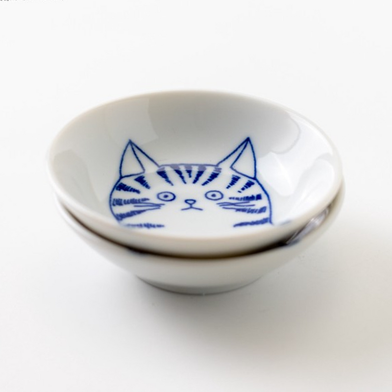 Two Shichita Mino Yaki cat side plates stacked together, highlighting the detailed cat illustration on the inner surface.