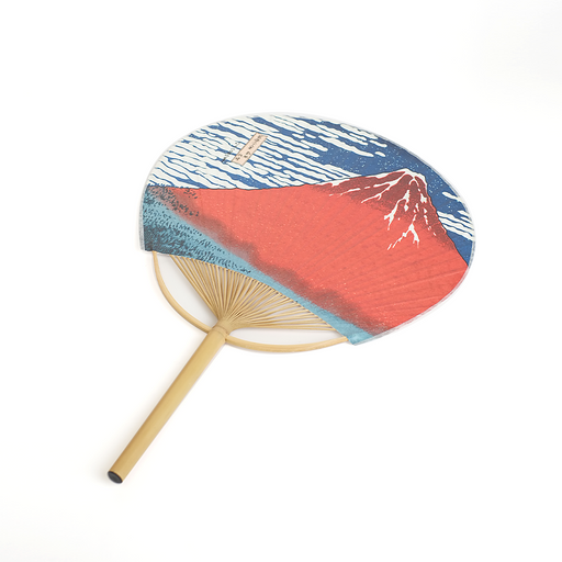 Shikoku Uchiwa round bamboo fan featuring Hokusai's Fine Wind Clear Weather (Red Fuji) ukiyo-e print — crimson Mount Fuji against a deep blue sky with white clouds — shown against a white background.
