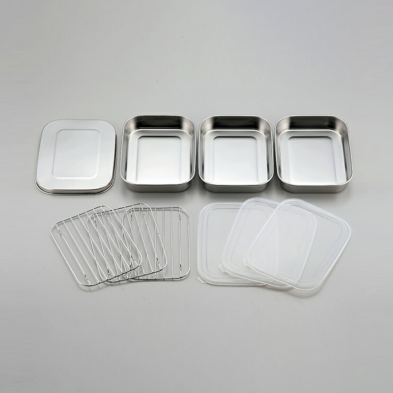 All 10 pieces of the Shimomura stainless steel food prep set laid out, showing the trays, wire racks, plastic lids, and stainless steel lid.

