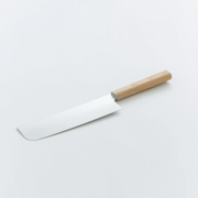 The Shizu Hamono Yuri Japanese Nakiri Knife (175mm) laid on a white surface, showcasing its minimalist design with a light wood handle and a clean, rectangular blade.
