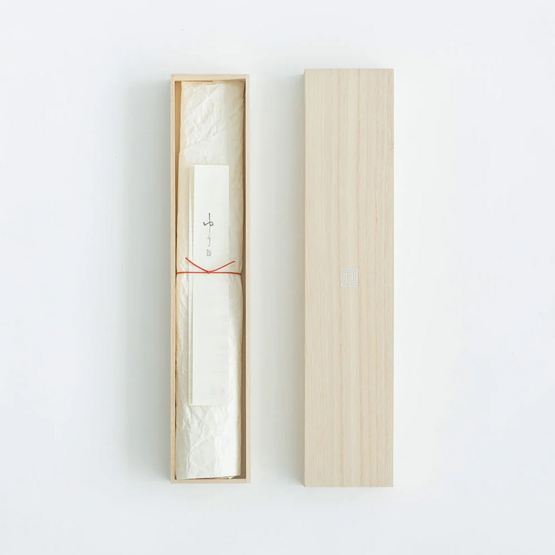 The knife comes in a beautifully crafted wooden box, with the knife and an accompanying paper insert wrapped in delicate white paper tied with a thin red string, offering a traditional and sophisticated presentation.