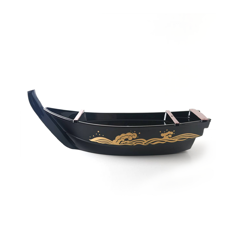 The Shogun serving platter, shaped like a traditional Japanese boat, in matte black with gold wave patterns, shown on its wooden stands.