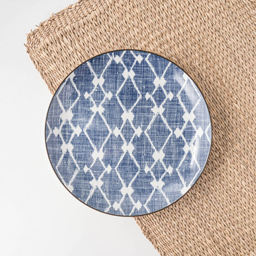 A Showa Seito Hishi plate with its classic blue and white diamond pattern, displayed on a natural woven placemat.