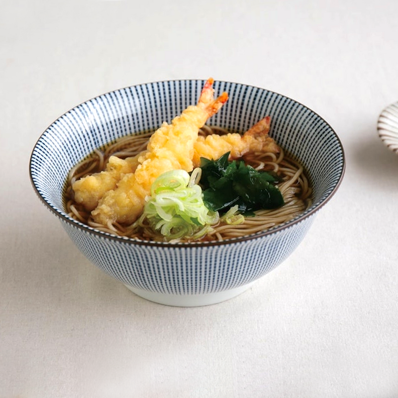 A top-down view of the Showa Seito Sendan Tokusa Donburi Bowl, showing the classic blue and white radiating line pattern inside the 21cm bowl.