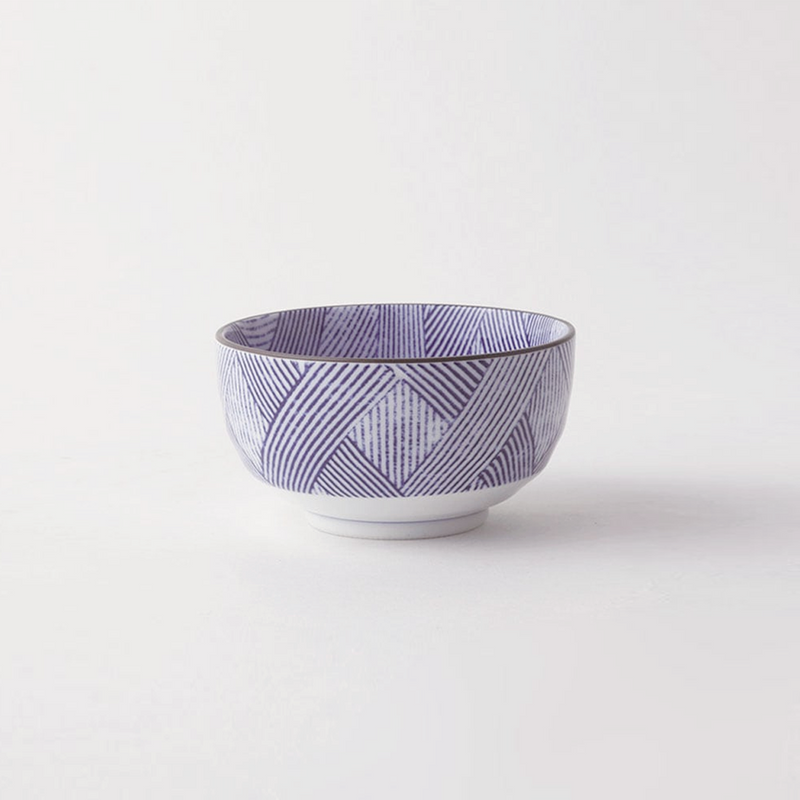 A purple and white porcelain Japanese bowl with a Shimakoushi geometric pattern of intersecting diagonal lines, featuring a grey rim, displayed empty on a plain white background.