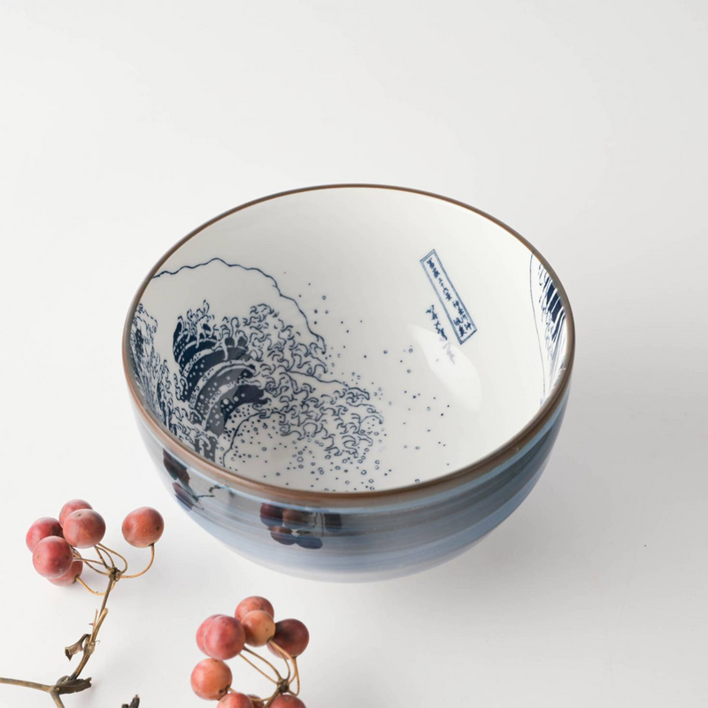 A 13cm diameter bowl with a traditional Japanese 'The Great Wave off Kanagawa' pattern, predominantly in blue and white colors, with the artist's signature visible.