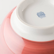 The base of the Showa Seito Donburi Bowl, showing the maker's mark on the tall white foot against the pink exterior.
