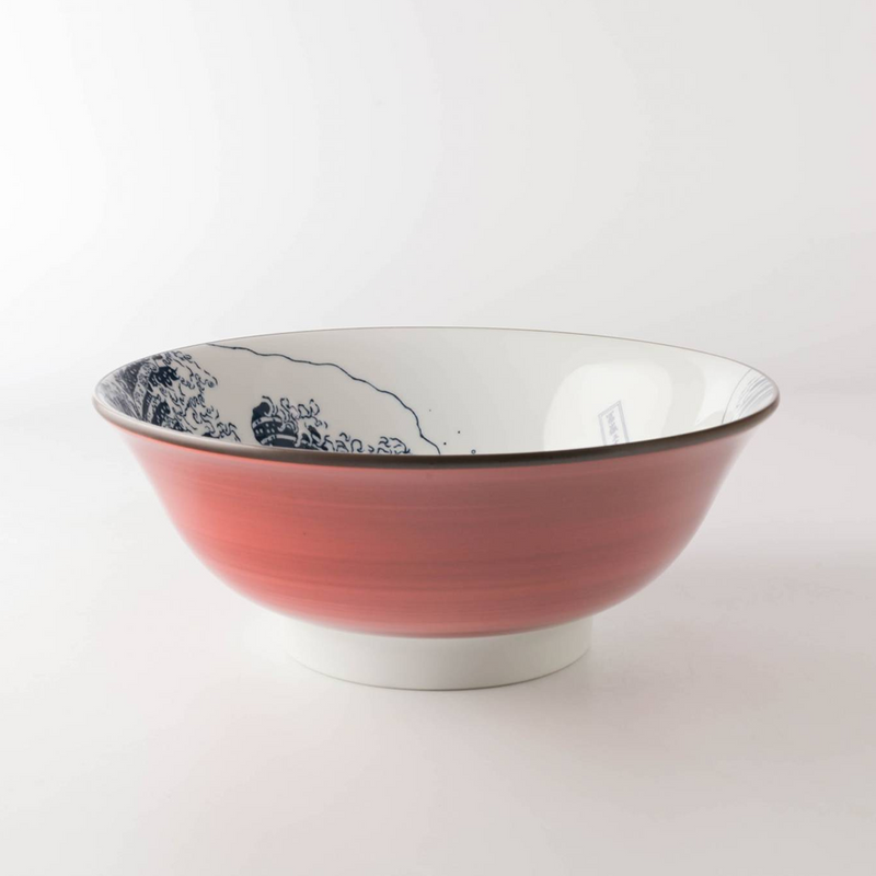 A side view of the Showa Seito 'The Great Wave' Donburi Bowl, showing its pink exterior and the iconic blue artwork visible on the inside rim.
