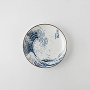 A 15.5cm porcelain plate with a blue and white Great Wave off Kanagawa pattern on a white background.